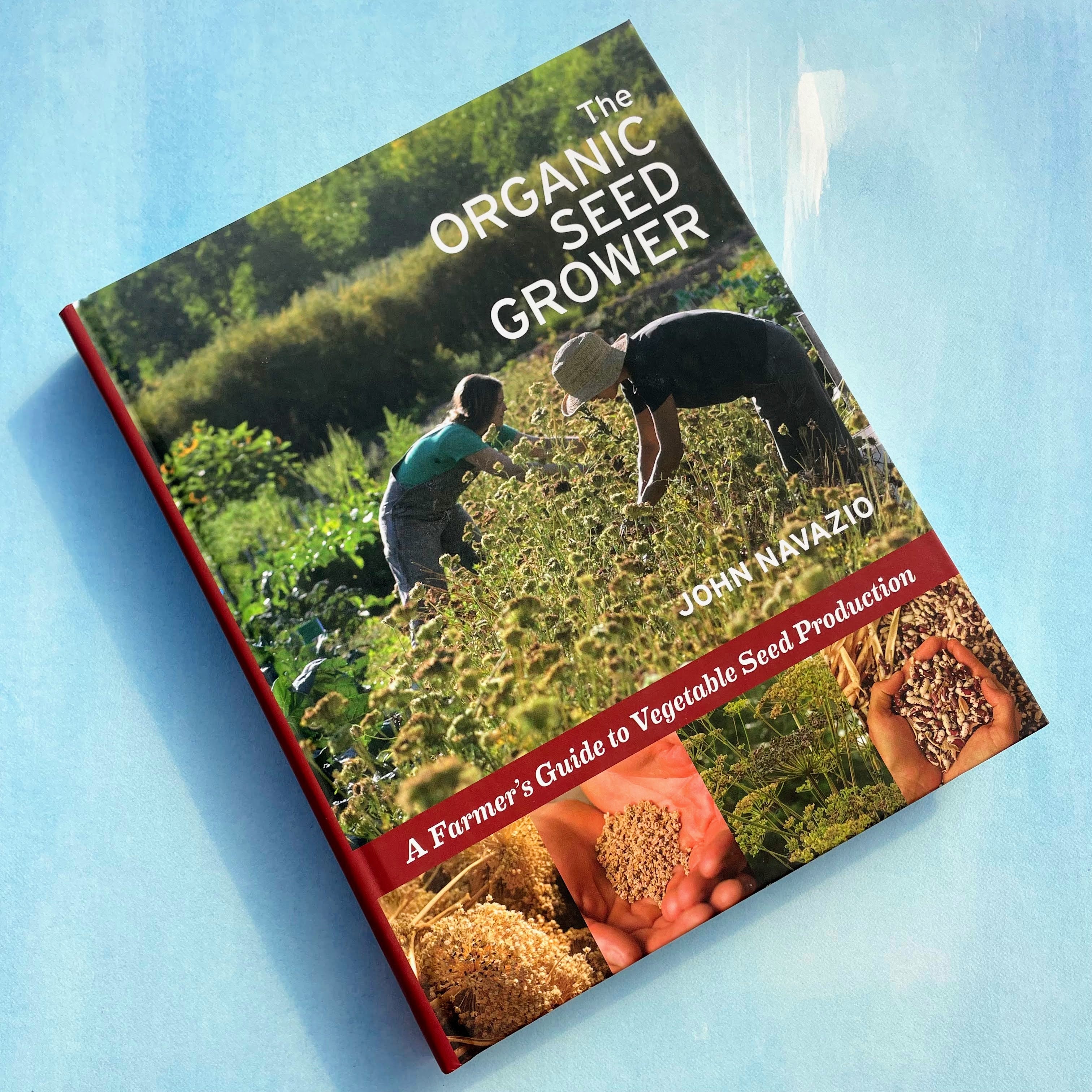 The Organic Seed Grower book by Chelsea Green Publishing, featuring a cover with seeds and gardening tools on a rustic background.