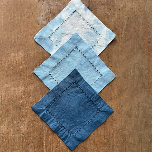 Set of indigo-dyed cocktail napkins from Botanical Colors 1-2-3 Indigo Dye Kit, featuring vibrant blue fabric with natural dye patterns.