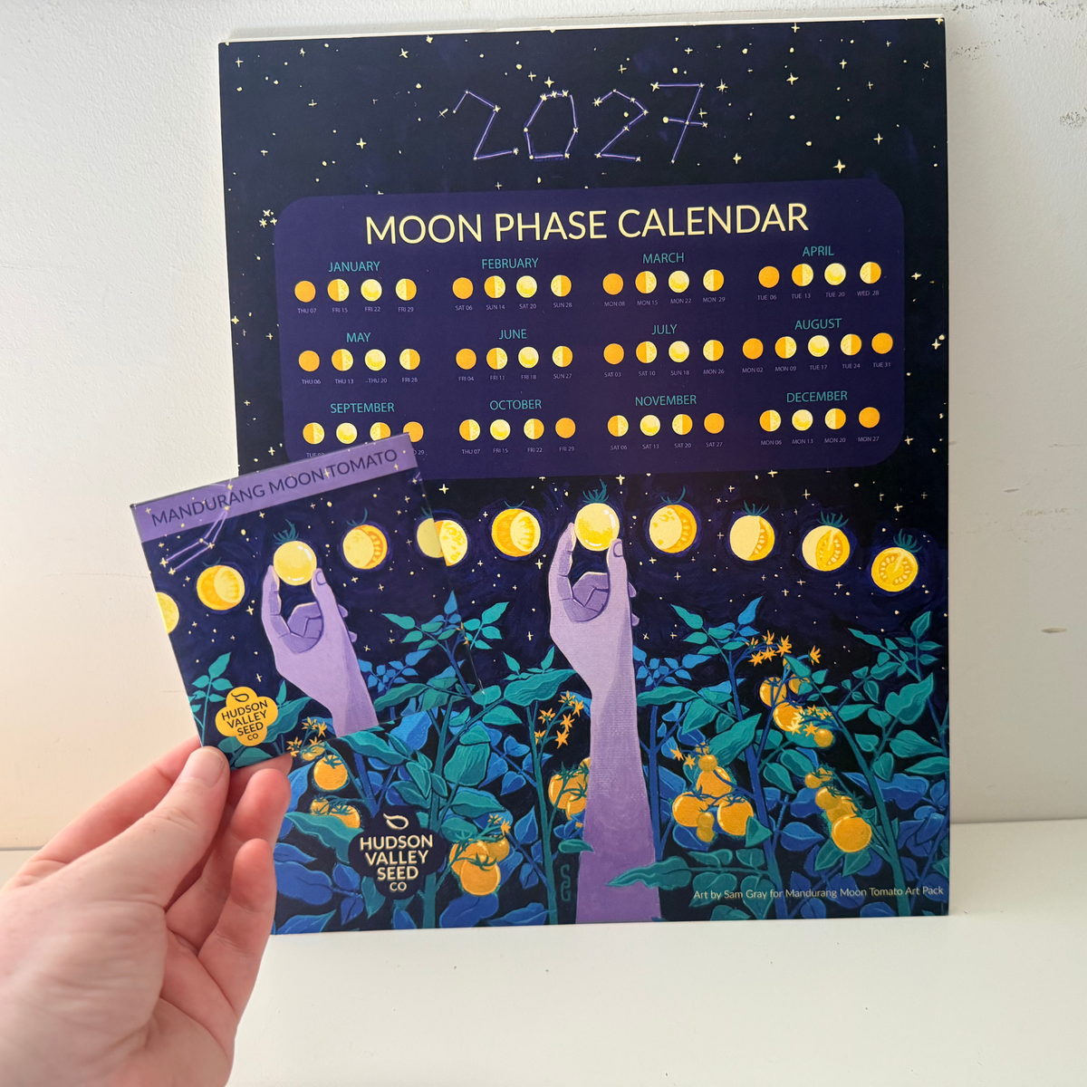 Fine art moon phase calendar by Hudson Valley Seed Co. showcasing detailed lunar phases in a artistic design.