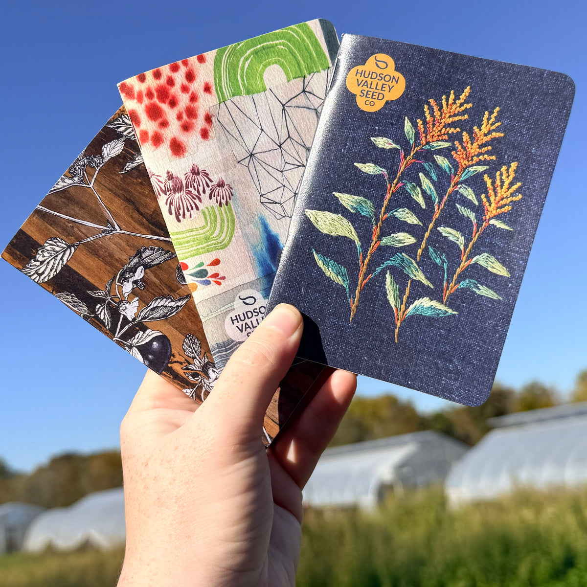 Three garden-themed notebooks from the HVSC Garden Notebook Trio set with colorful covers and floral designs.