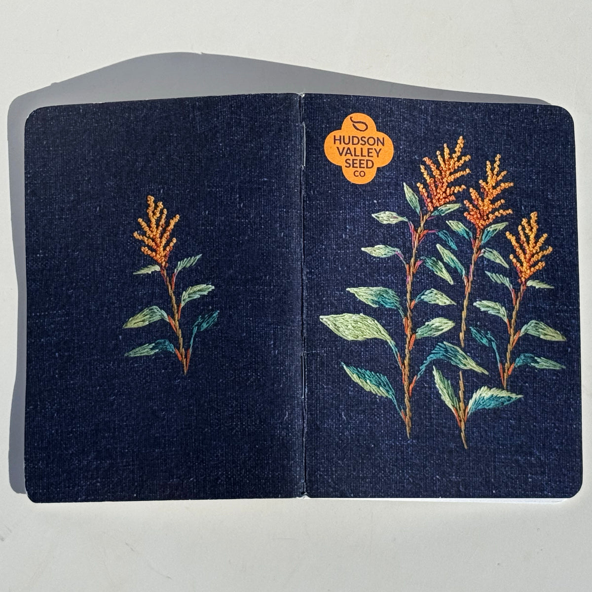 Set of three HVSC garden notebooks with floral covers, featuring blank pages for gardening notes and planning.