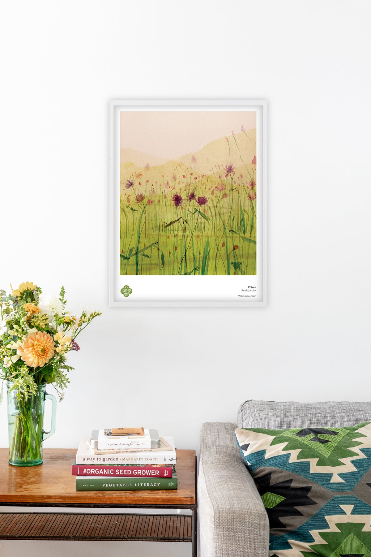 Fine art poster featuring chives, with vibrant green herb illustrations, from Hudson Valley Seed Co. in a living room setting.