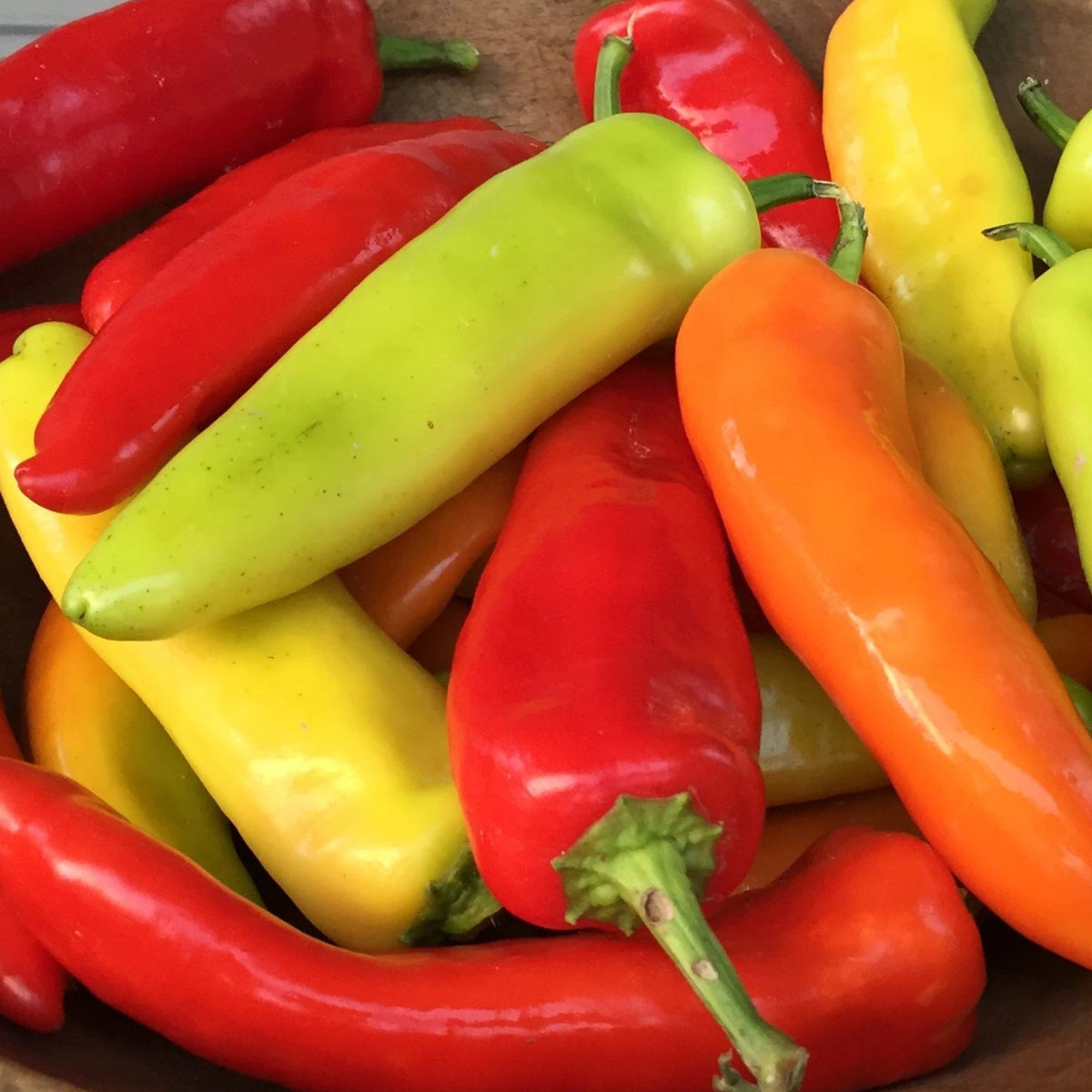 Hungarian Hot Wax vegetables from Hudson Valley Seed Co., vibrant yellow-orange peppers on display.