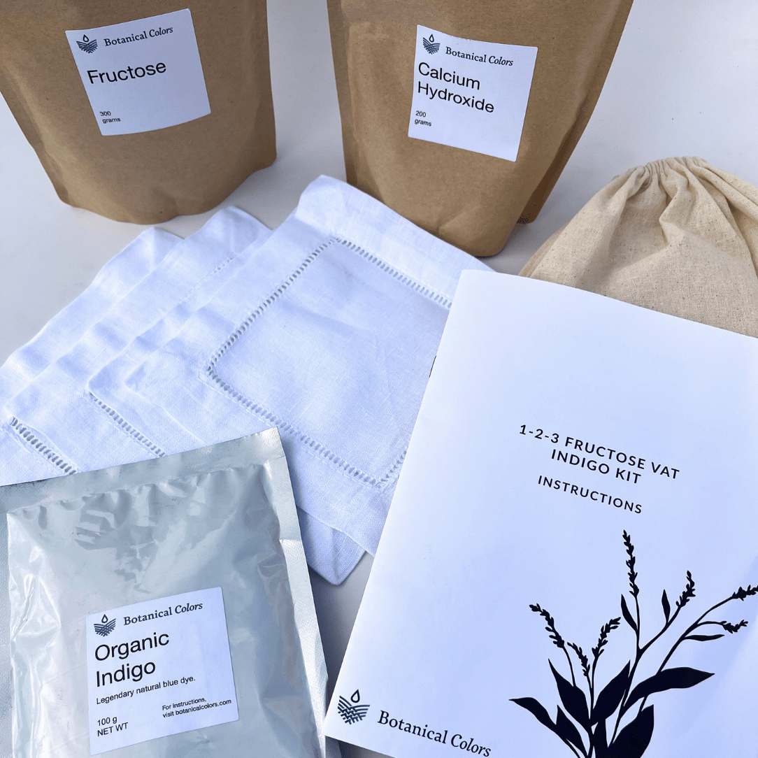 Botanical Colors 1-2-3 Indigo Dye Kit for natural fabric dyeing, featuring dye powders, gloves, and instructions in a gift shop package.