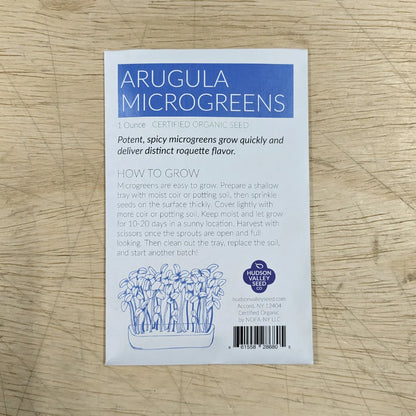 Fresh arugula microgreens in a Hudson Valley Seed Co. microgreens starter kit, showcasing vibrant green vegetable microgreens.
