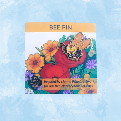 Bee Nectary bee enamel pin from Hudson Valley Seed Co. displayed with artwork card featuring a detailed bee design.