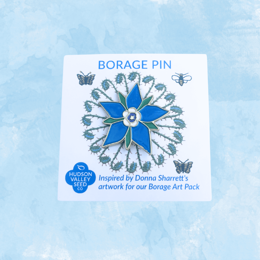 Borage enamel pin from Hudson Valley Seed Co. featuring detailed borage flower design, displayed alongside a decorative art card.