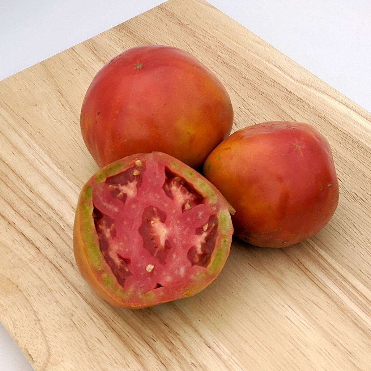 Bright red Cosmonaut Volkov tomato from Hudson Valley Seed Co., showcasing its round shape and smooth skin.