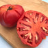 Prudens Purple Tomato from Hudson Valley Seed Co., vibrant purple heirloom vegetable with smooth skin and ripe, round shape.