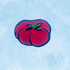 Mikado Tomato enamel pin from a gift shop, featuring a bright red tomato design on a metal pin back.