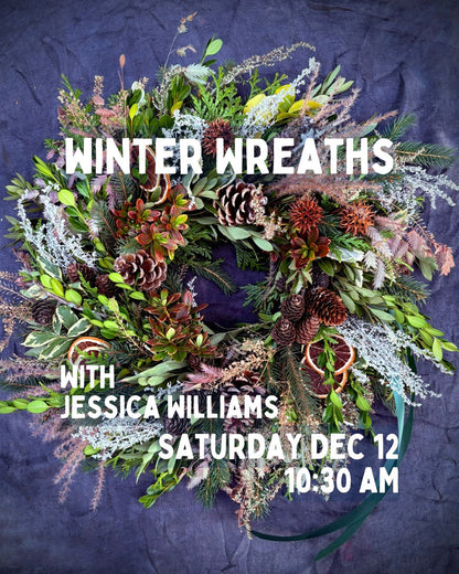 Decorative winter wreath featuring festive greenery and ornaments, displayed at a Jessica Williams event.
