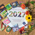 2027 Art of Seed Calendar by Hudson Valley Seed Co., featuring botanical illustrations and monthly seed planting tips.