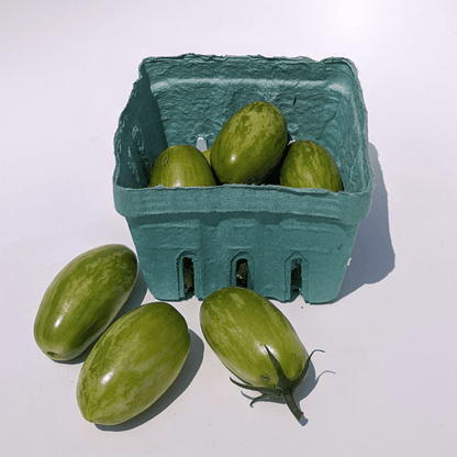 Green Tiger Tomato vegetable from vendor-unknown, showing a vibrant green, striped tomato with smooth skin and distinctive tiger-like pattern.