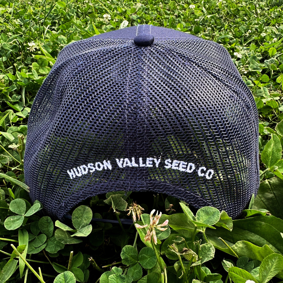 Mesh back trucker hat from Hudson Valley Seed Co with adjustable strap and logo embroidery, designed for casual wear.