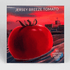 Fresh Jersey Breeze Tomato from Hudson Valley Seed Co., showcasing ripe, vibrant red vegetables on the plant.