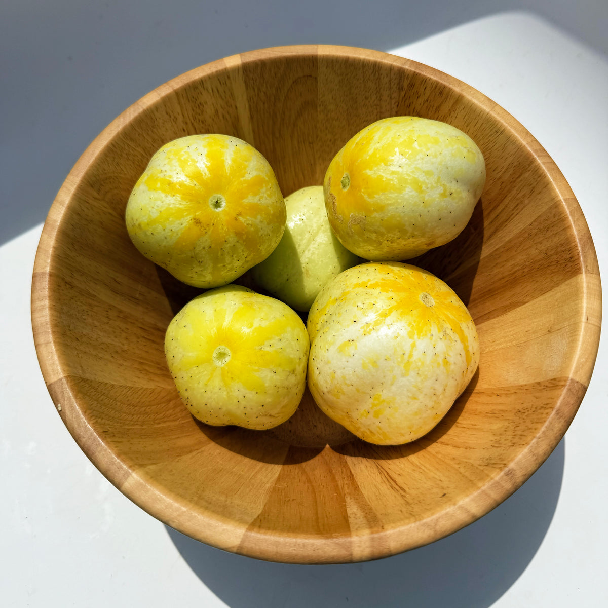 Fresh lemon cucumbers from Hudson Valley Seed Co., vibrant yellow-green vegetables with smooth skin and crisp texture.