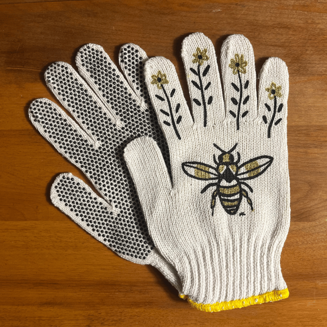 Printed garden gloves by My Little Belleville featuring bee patterns, made of durable fabric for gardening and outdoor tasks.