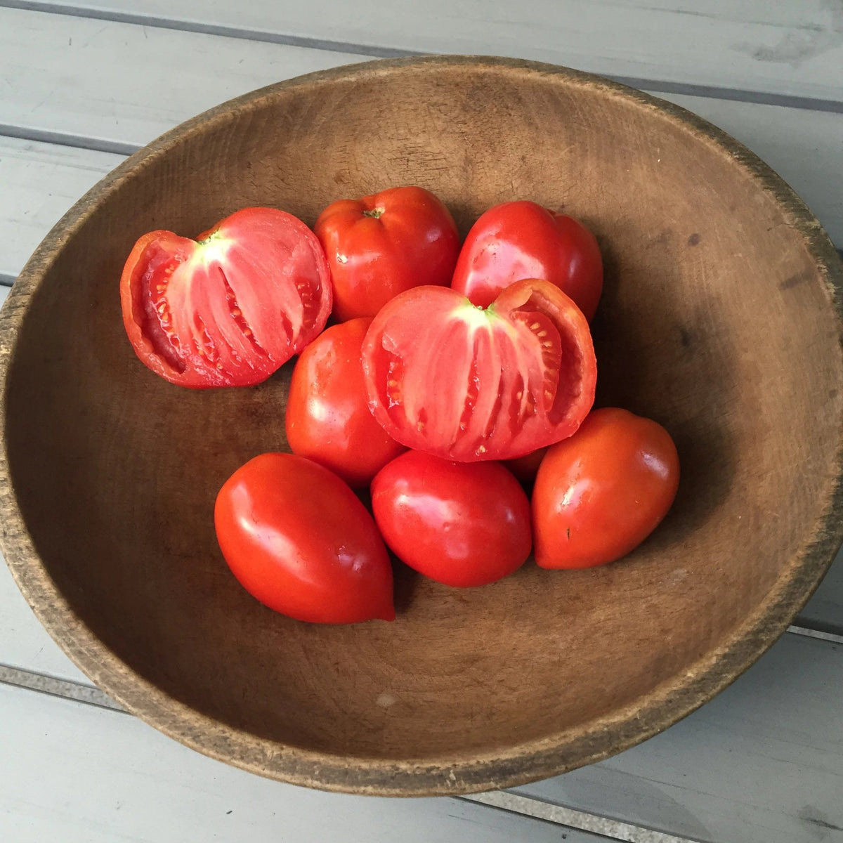 Heirloom Amish Paste Tomato from Hudson Valley Seed Co., fresh, ripe, and vibrant red vegetable on display at a vendor stall.