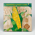 Fresh Ashworth Sweet Corn, a vegetable from Hudson Valley Seed Co., displayed with husks and bright yellow kernels.