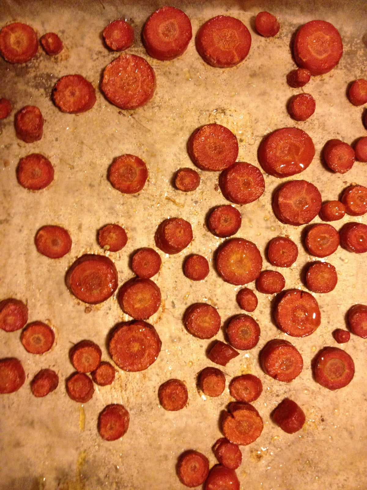 Fresh Atomic Red Carrot from Hudson Valley Seed Co., showcasing its vibrant color and crunchy texture on a vegetable display.
