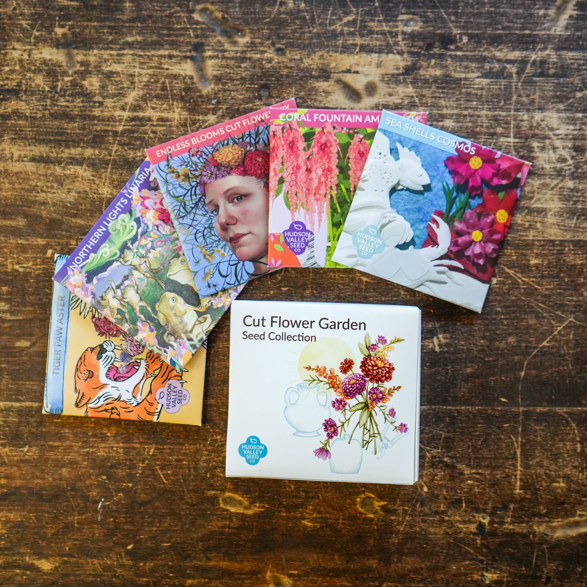 Assorted colorful cut flower garden seeds from Hudson Valley Seed Co. arranged in seed packets.