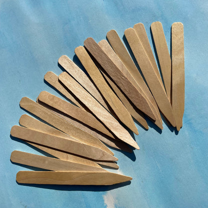 Six-inch wooden plant labels for gardening, natural wooden tags for marking plants and seedlings in garden beds.