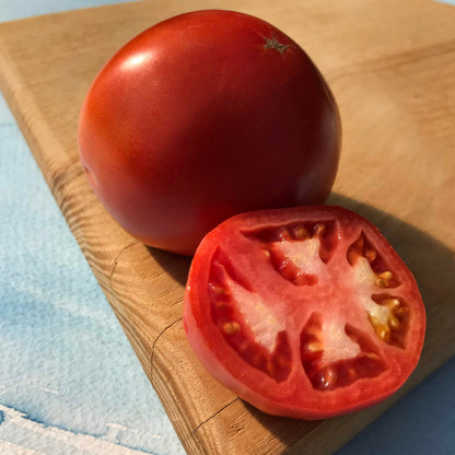 Fresh Rutgers tomato from Hudson Valley Seed Co., showcasing a ripe, vibrant red vegetable on the vine.