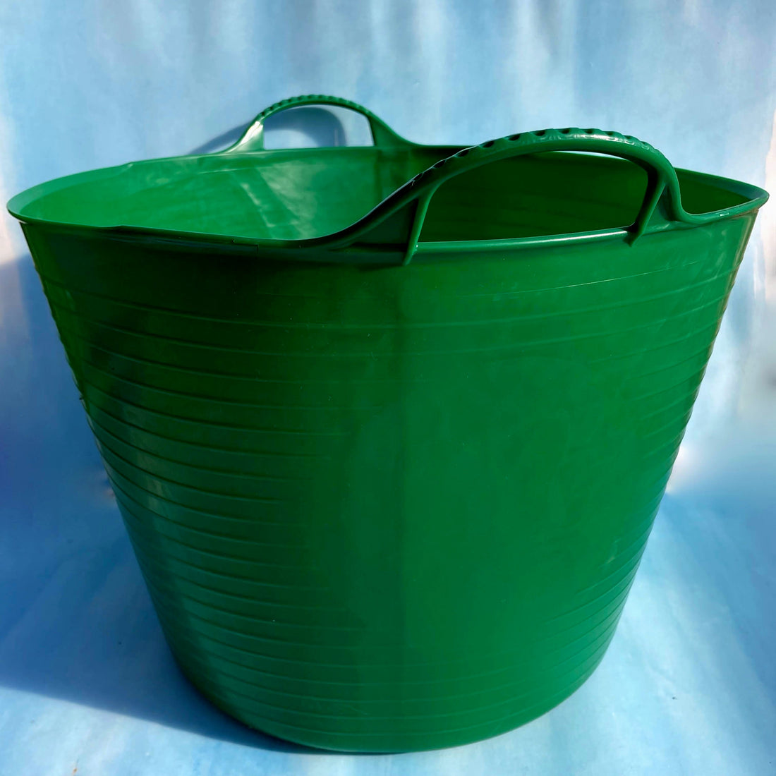 Red Gorilla 10-gallon garden tub for tools and supplies, made of durable plastic with a sturdy handle and spacious interior.