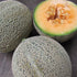 Fresh Iroquois cantaloupe vegetable from Hudson Valley Seed Co. displayed at a vendor stand, showcasing its ripe, orange interior.