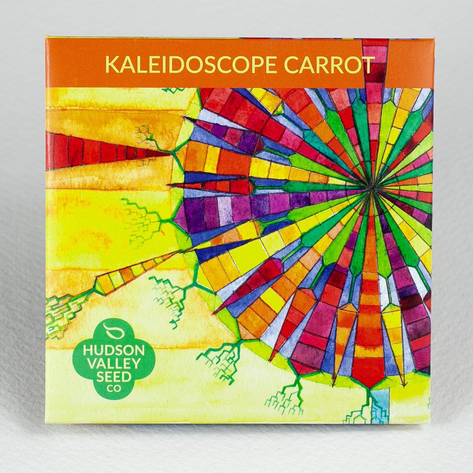 Colorful kaleidoscope carrots from Hudson Valley Seed Co., vibrant orange, purple, and yellow vegetables displayed in a rustic setting.