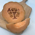 Minnesota Mini Melon vegetable from Hudson Valley Seed Co., small round melon with green striped skin and orange flesh.