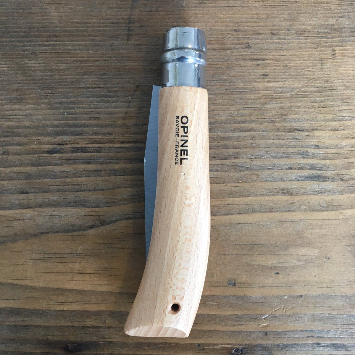 Opinel folding saw knife with wooden handle and metal blade, ideal for camping and outdoor cutting tasks