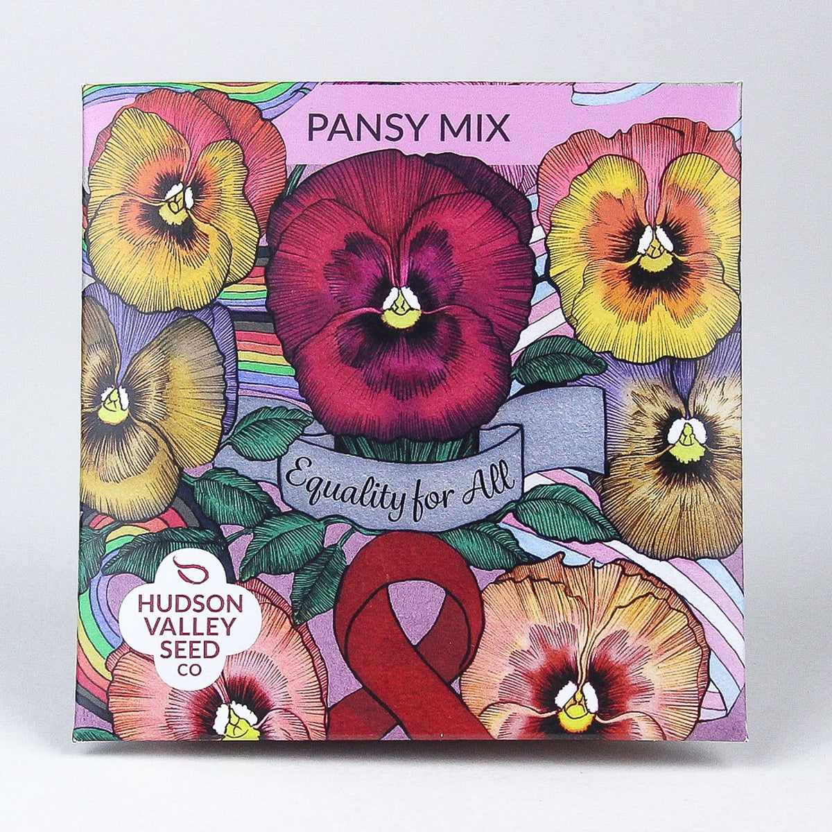 Colorful pansy mix flowers from Hudson Valley Seed Co. arranged in a garden bed, showcasing vibrant purple, yellow, and blue blooms.