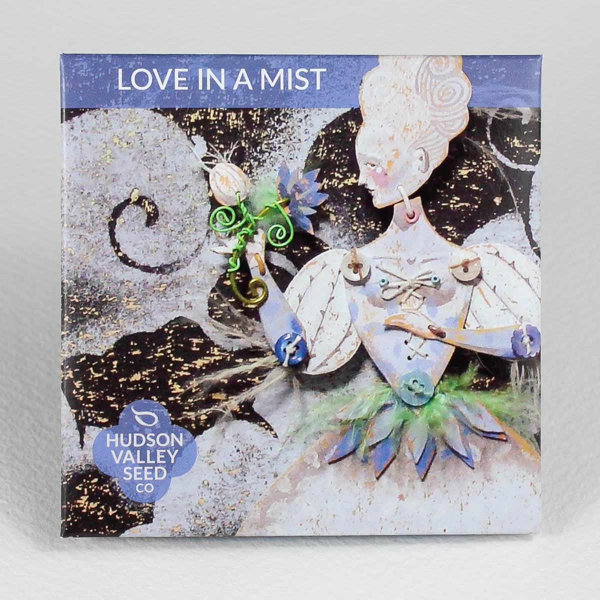Love in a Mist flower seedlings from Hudson Valley Seed Co. showcasing vibrant blue and delicate foliage in a garden setting.